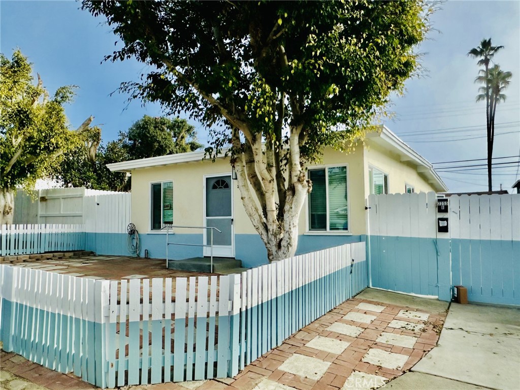 a view of a house with wooden fence