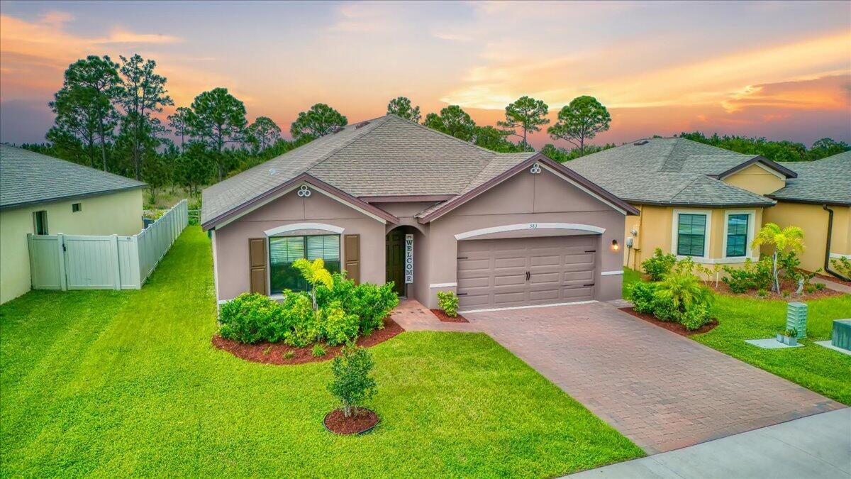 a front view of a house with garden