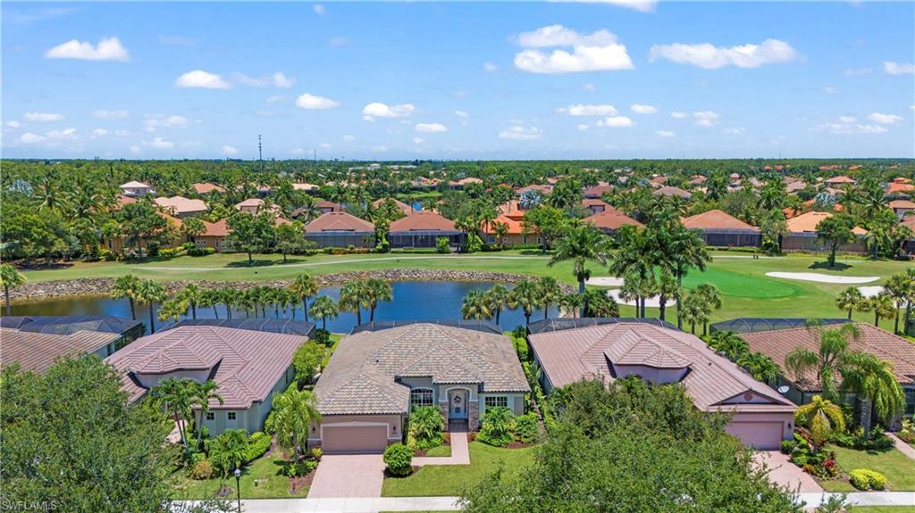 Birds eye view of property with a water view