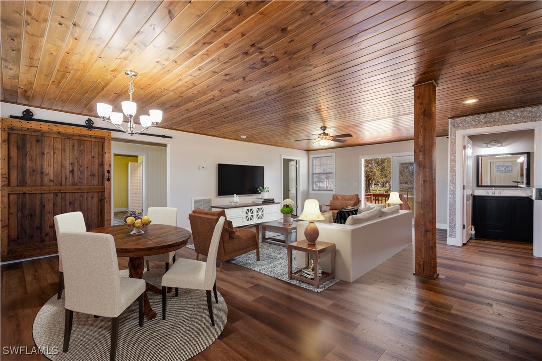 a view of a dining room with furniture wooden floor and chandelier