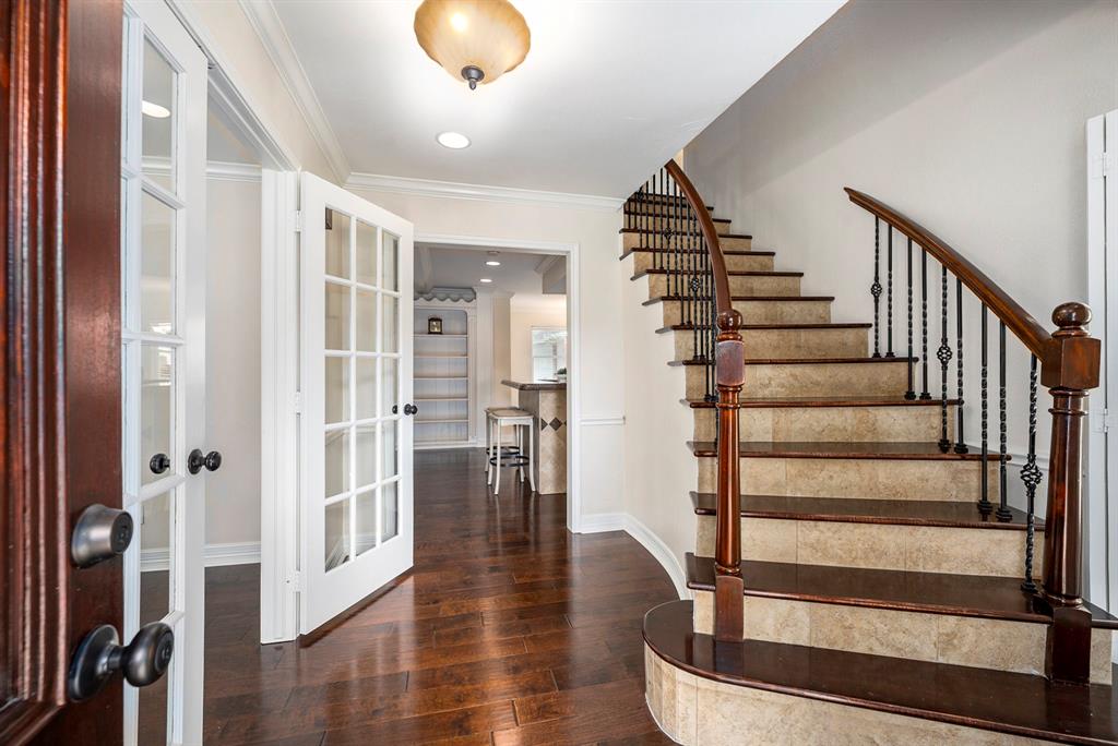 a view of entryway with wooden floor and stairs