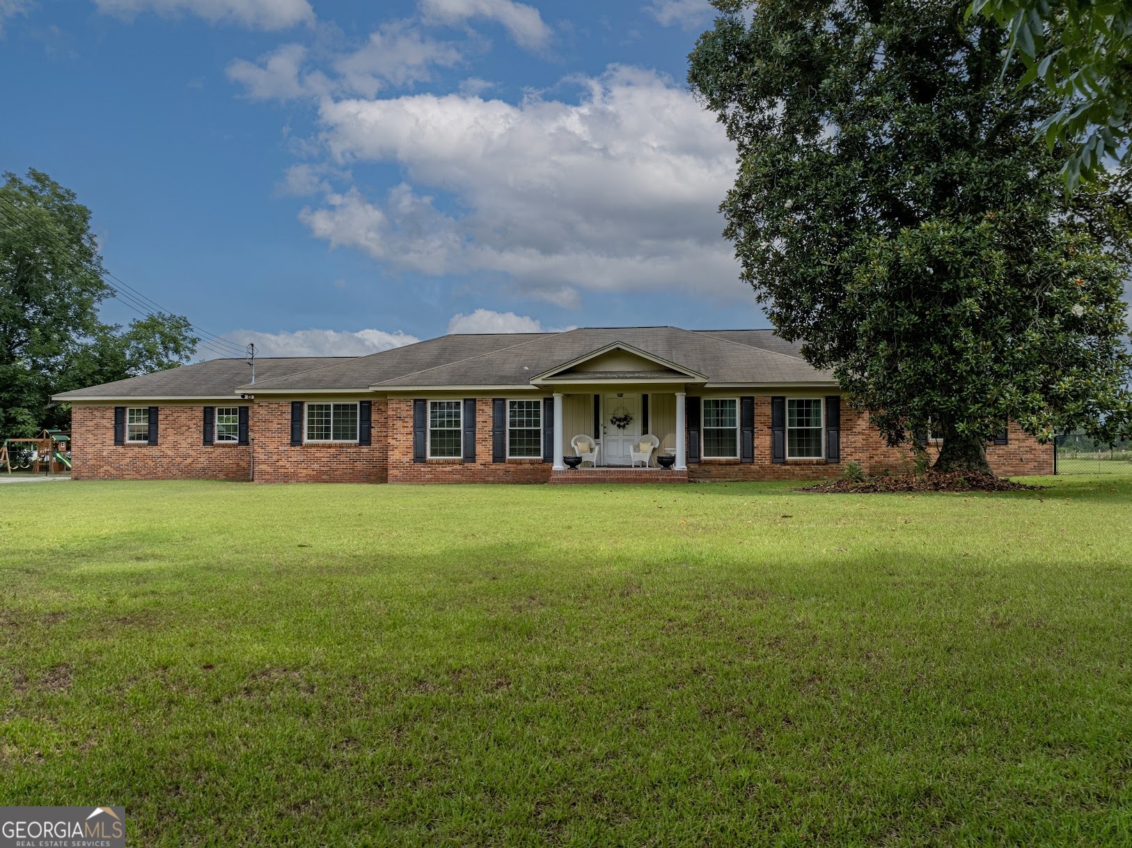 a front view of a house with a garden