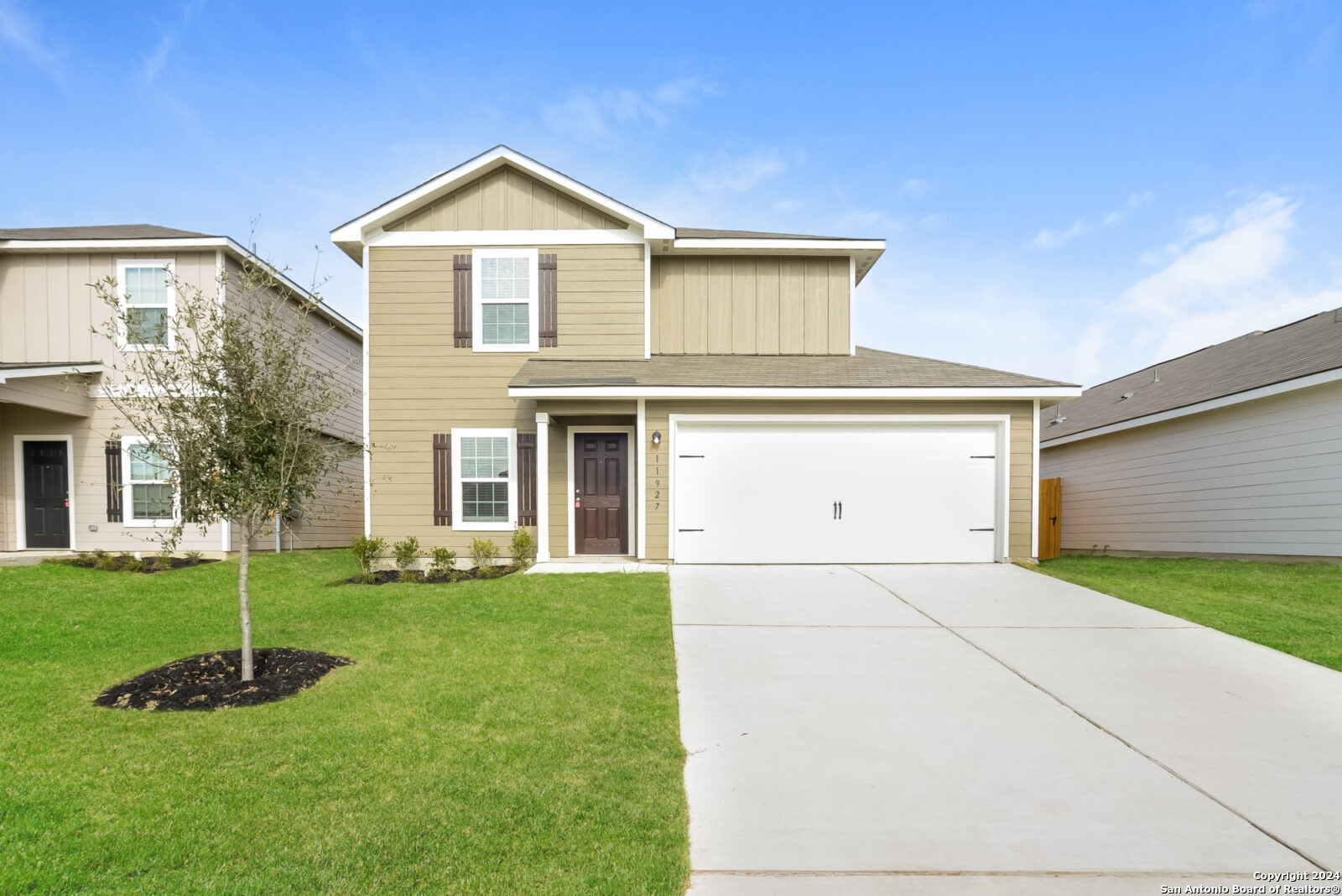 a front view of a house with a yard