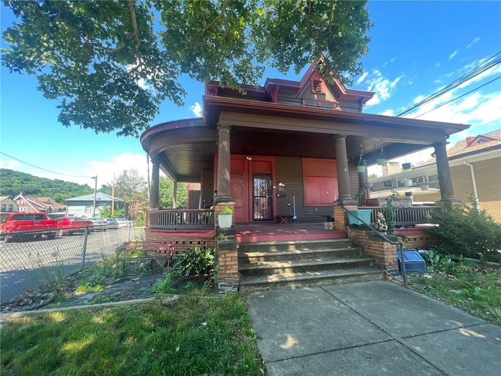 a view of a house with a yard balcony and furniture