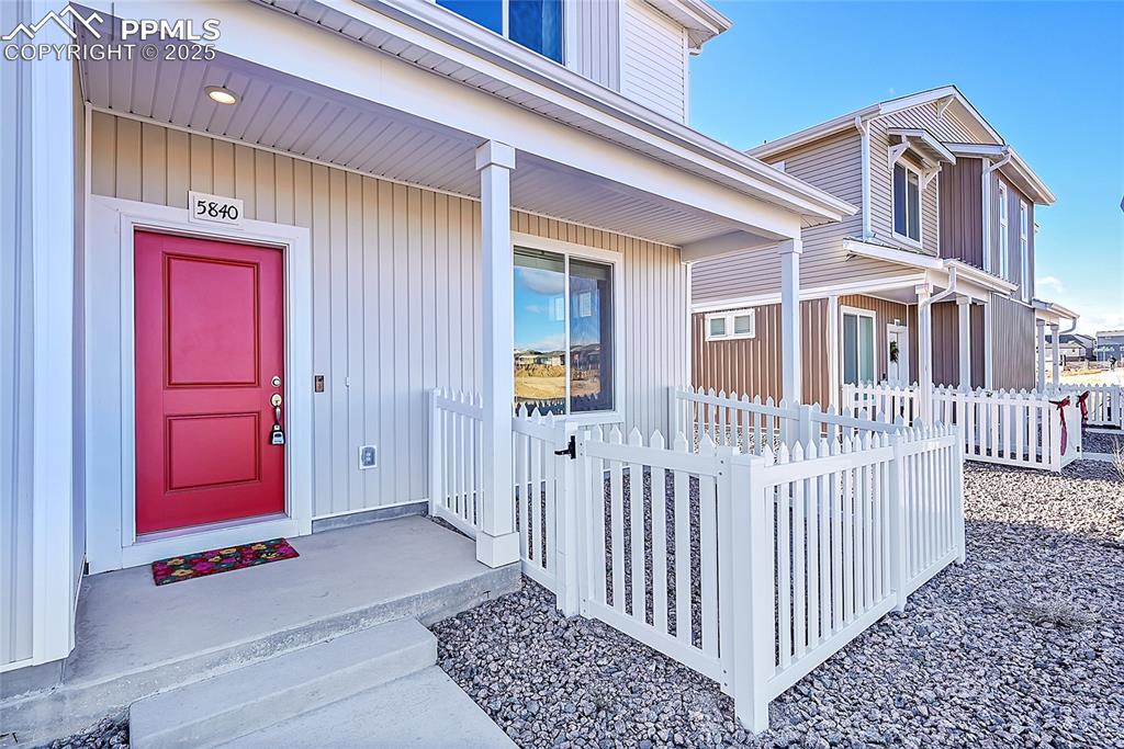 Doorway to property featuring covered porch