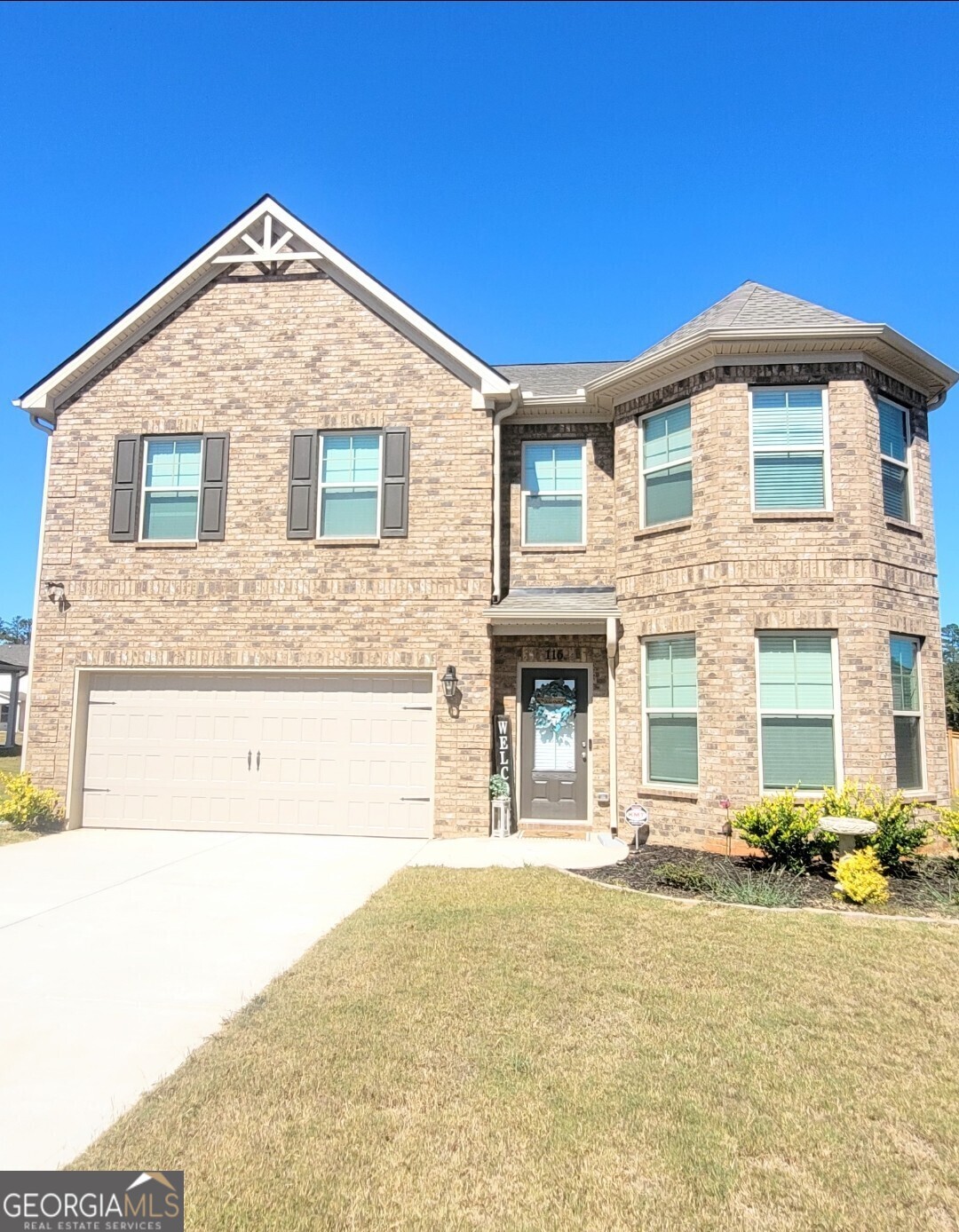 a front view of a house with a yard