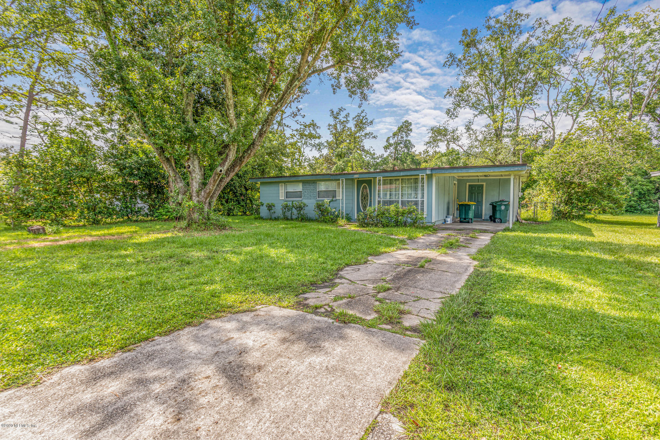 a front view of house with yard and green space