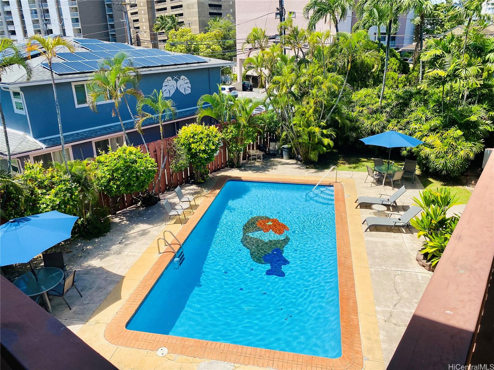 a view of swimming pool with a lounge chairs