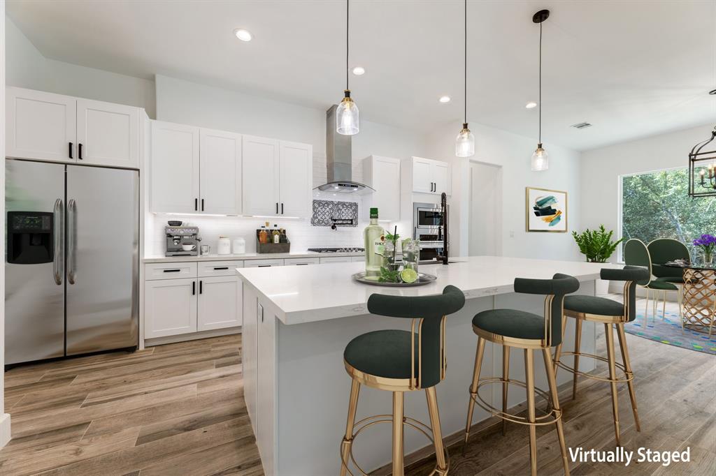 a kitchen with stainless steel appliances kitchen island wooden cabinets and white appliances