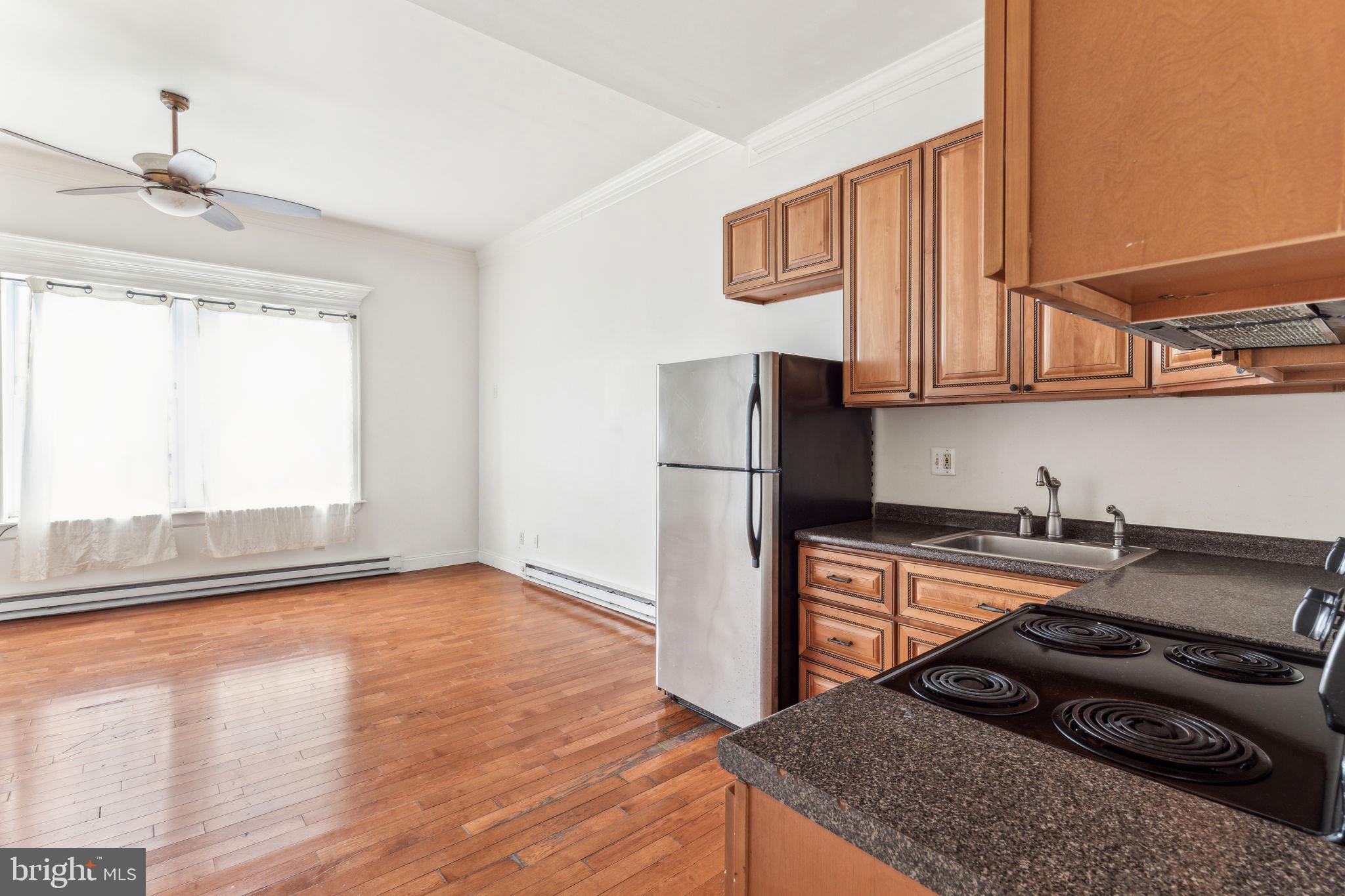 a kitchen with a stove a refrigerator and a sink