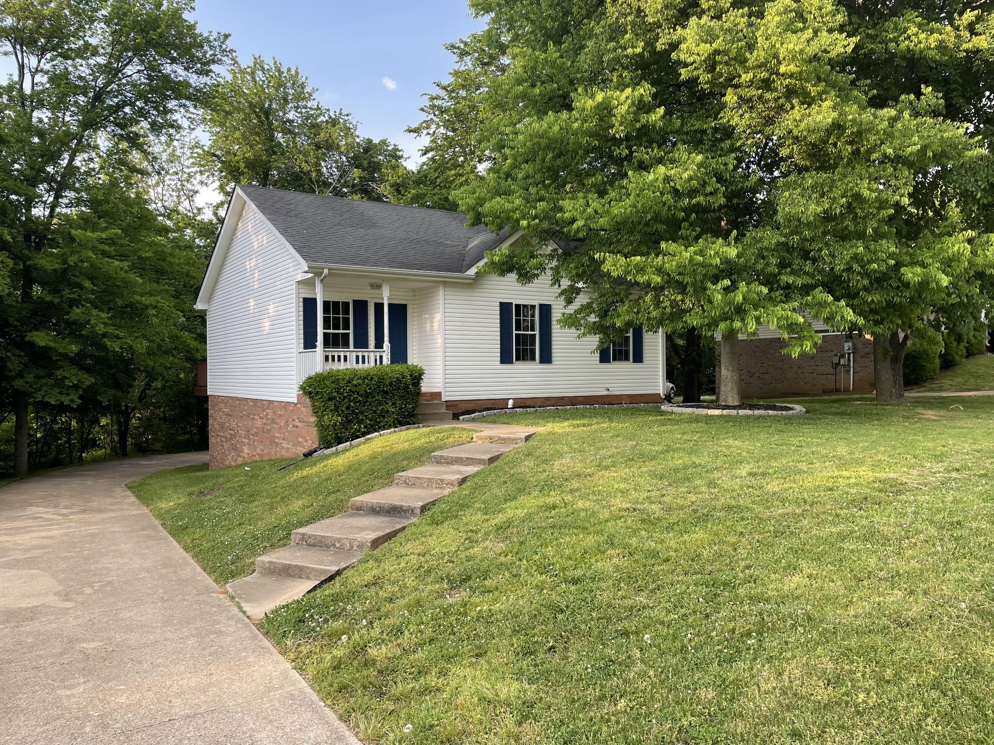 a front view of house with yard and trees