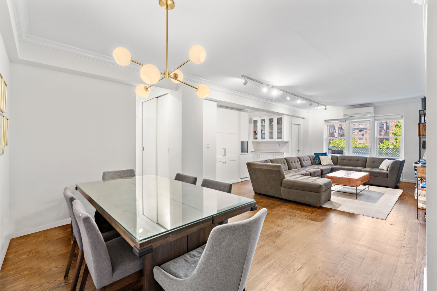 a living room with furniture and a chandelier