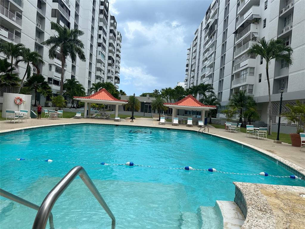 a view of swimming pool with outdoor seating and yard