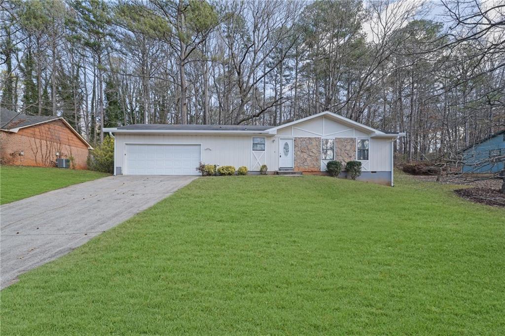 a front view of house with yard and green space