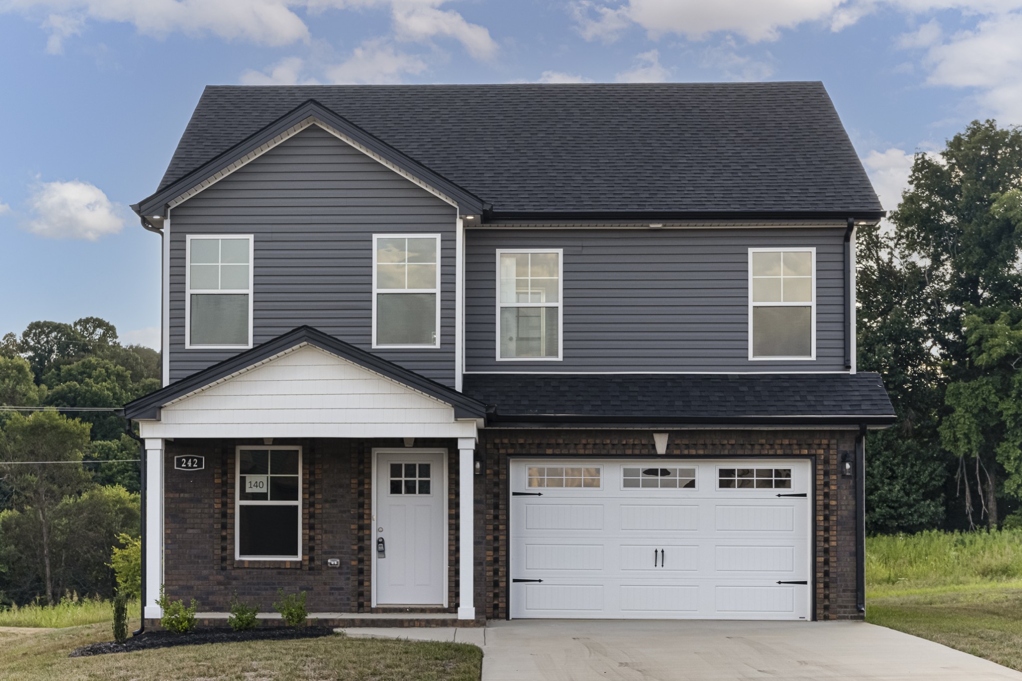 a front view of a house with a yard