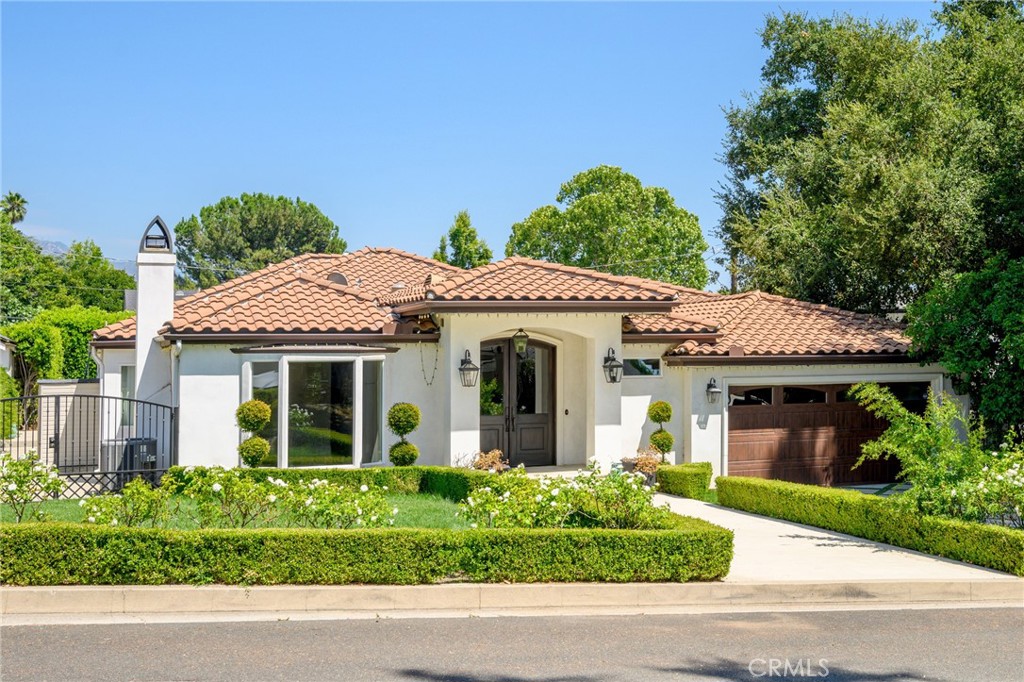 a front view of a house with a garden