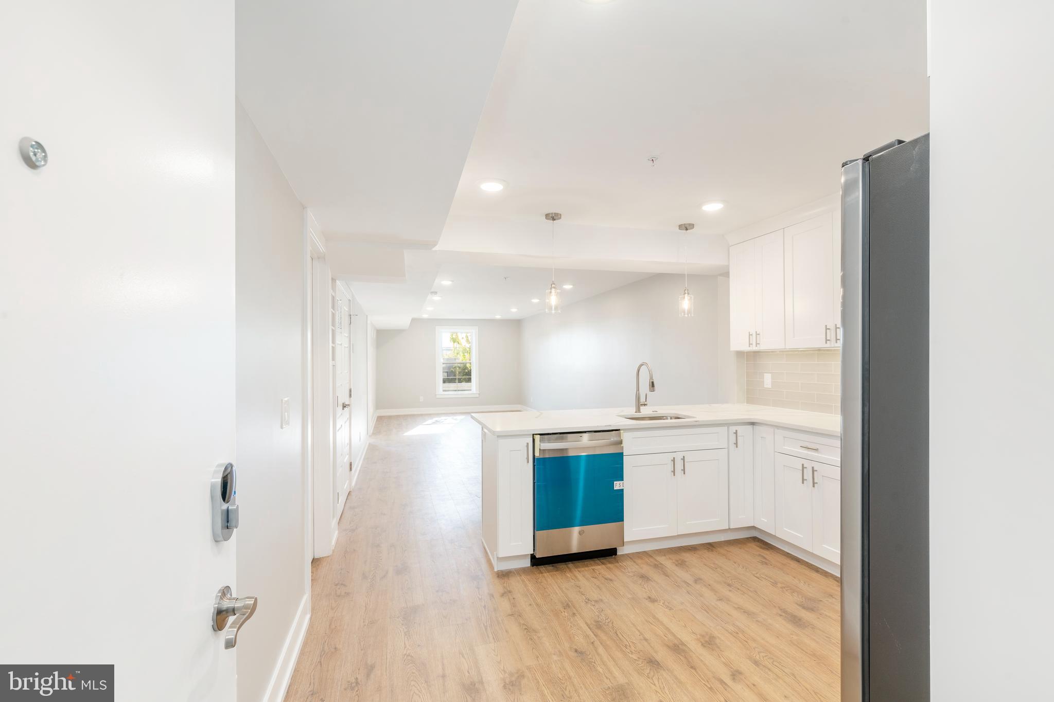 a large kitchen with a sink and cabinets