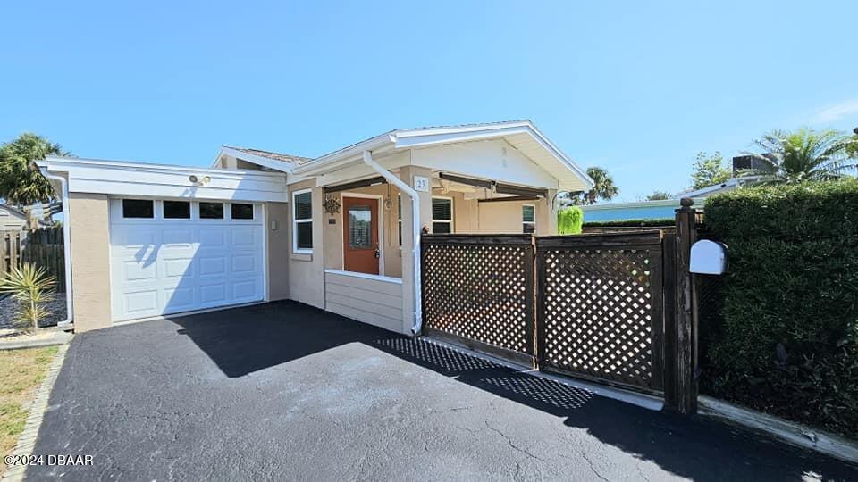 a view of a house with wooden fence