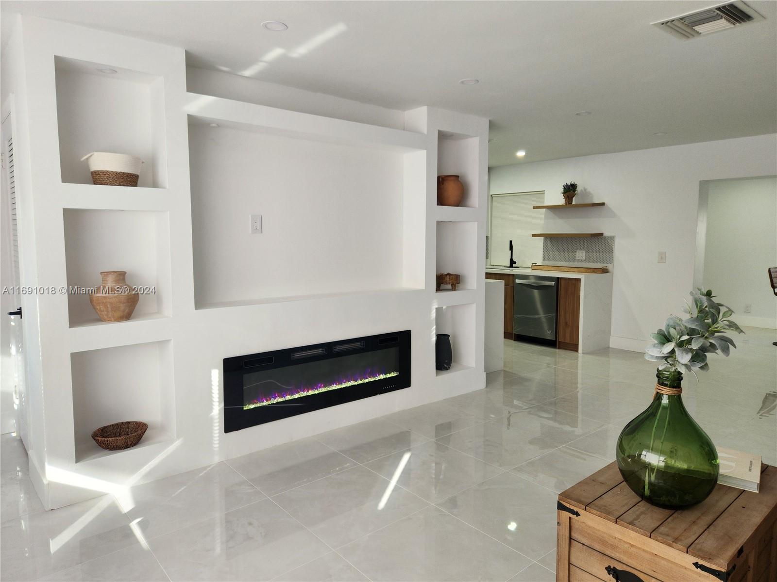 a kitchen with stainless steel appliances kitchen island granite countertop a stove and a refrigerator