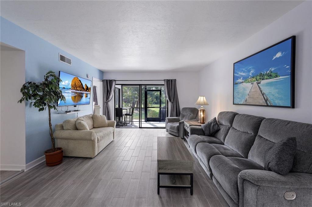 a living room with furniture and a potted plant