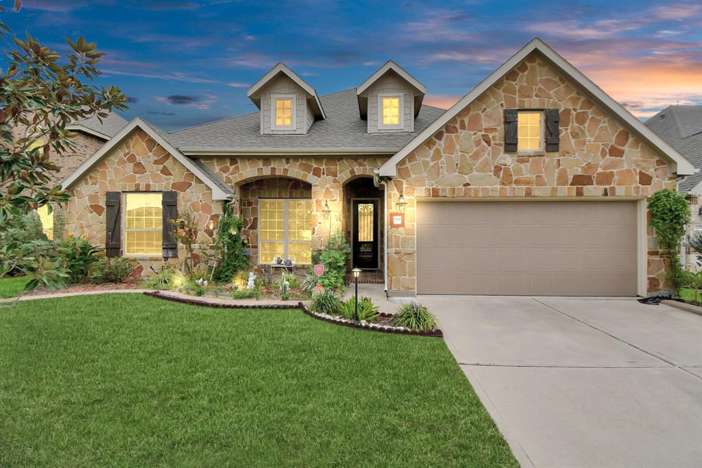 a front view of a house with a yard and garage