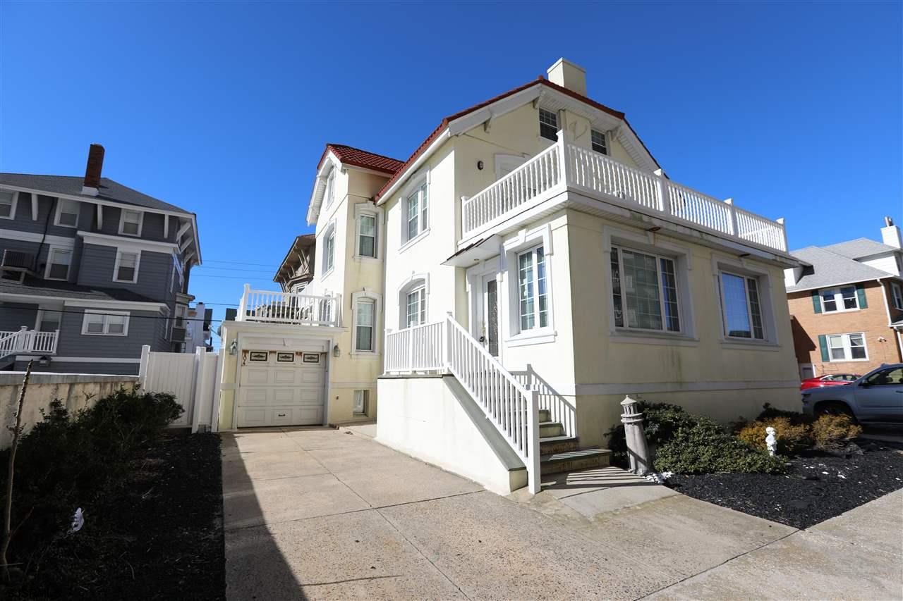 a front view of a residential apartment building with a yard