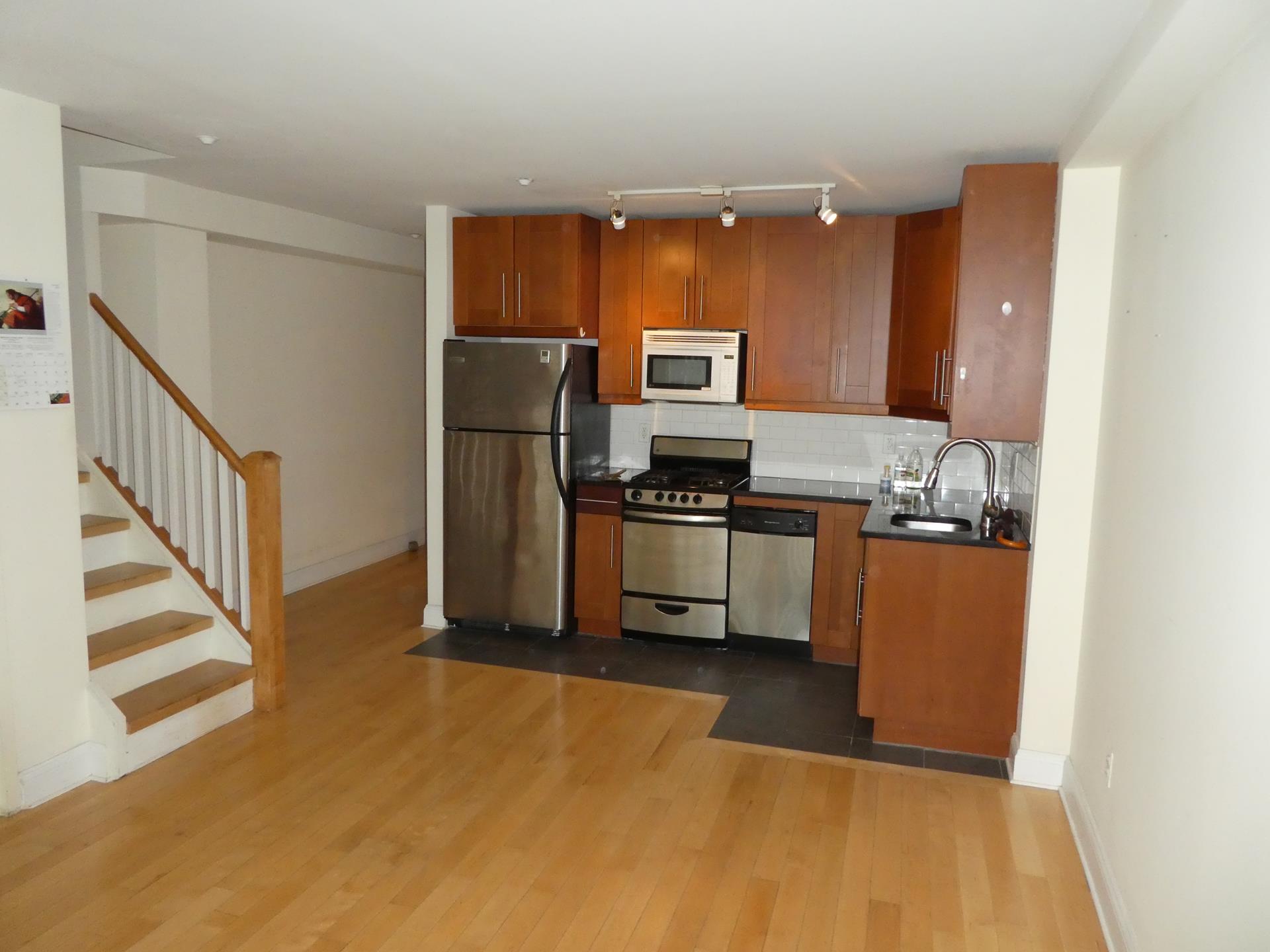 a kitchen with stainless steel appliances a refrigerator and a stove top oven