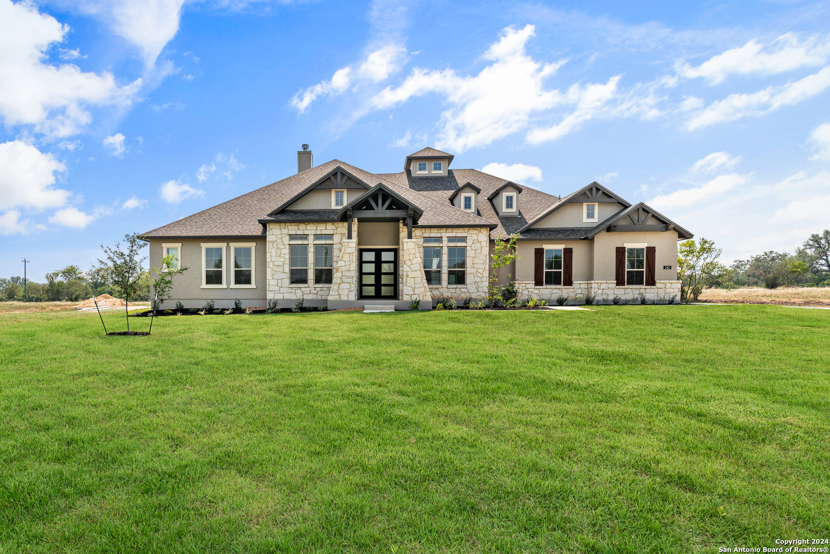 a front view of a house with a garden