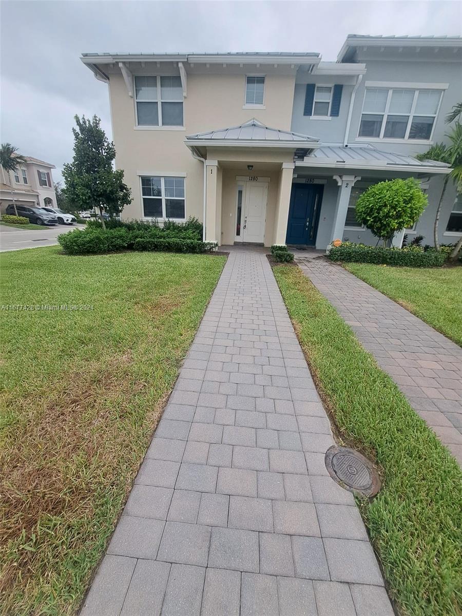 a front view of a house with a yard