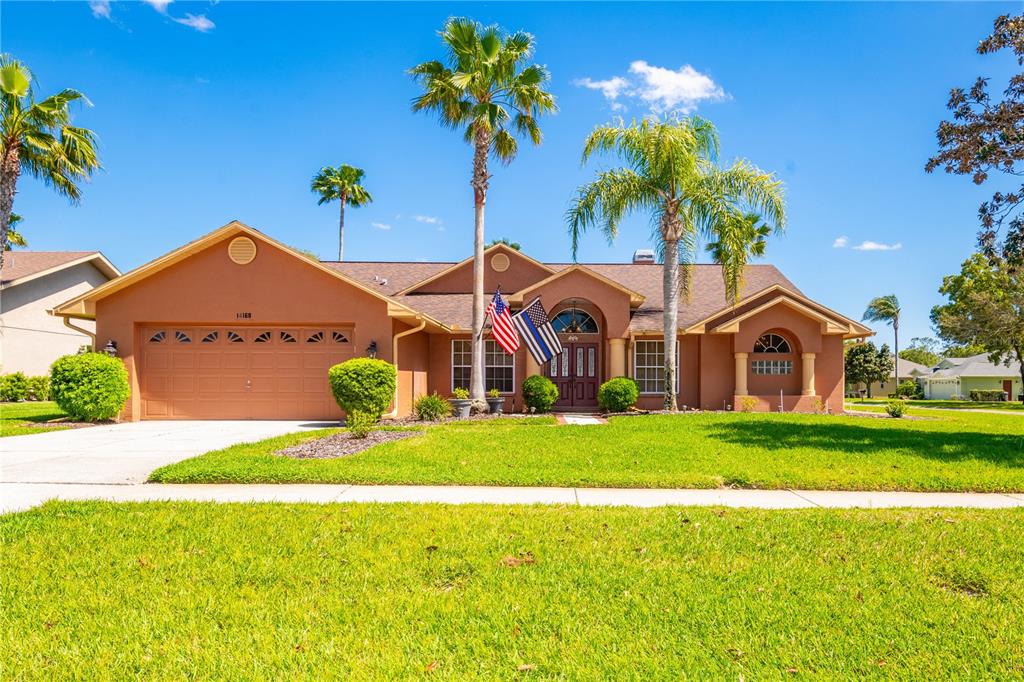 a front view of a house with a yard and garage