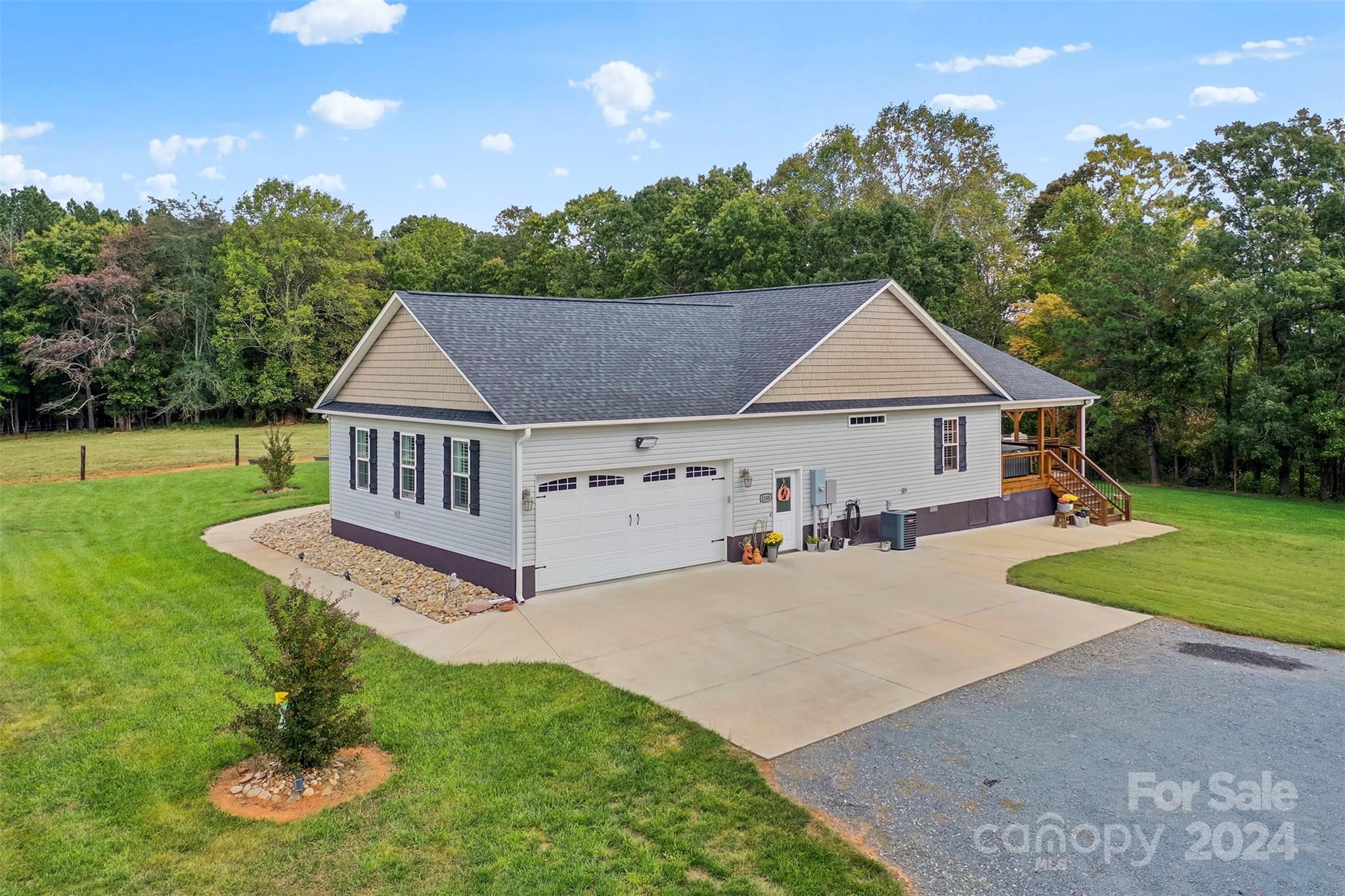 a aerial view of a house with yard and a garden