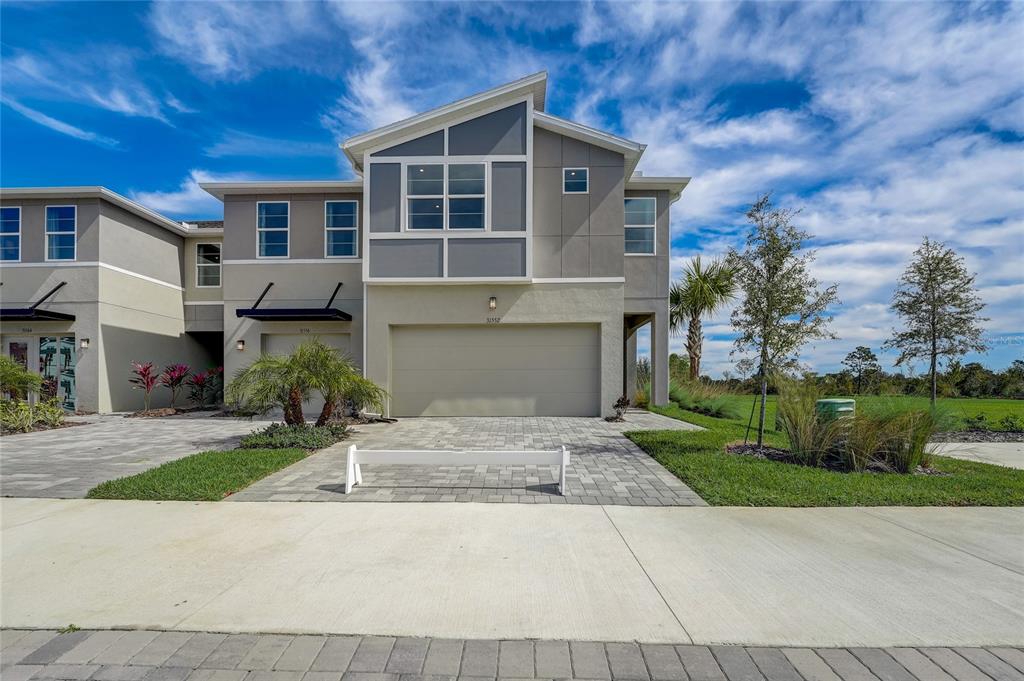 a front view of a house with a yard and garage