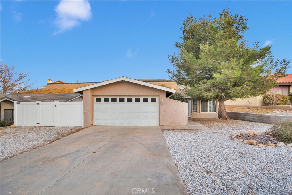 a view of a house with a yard and garage