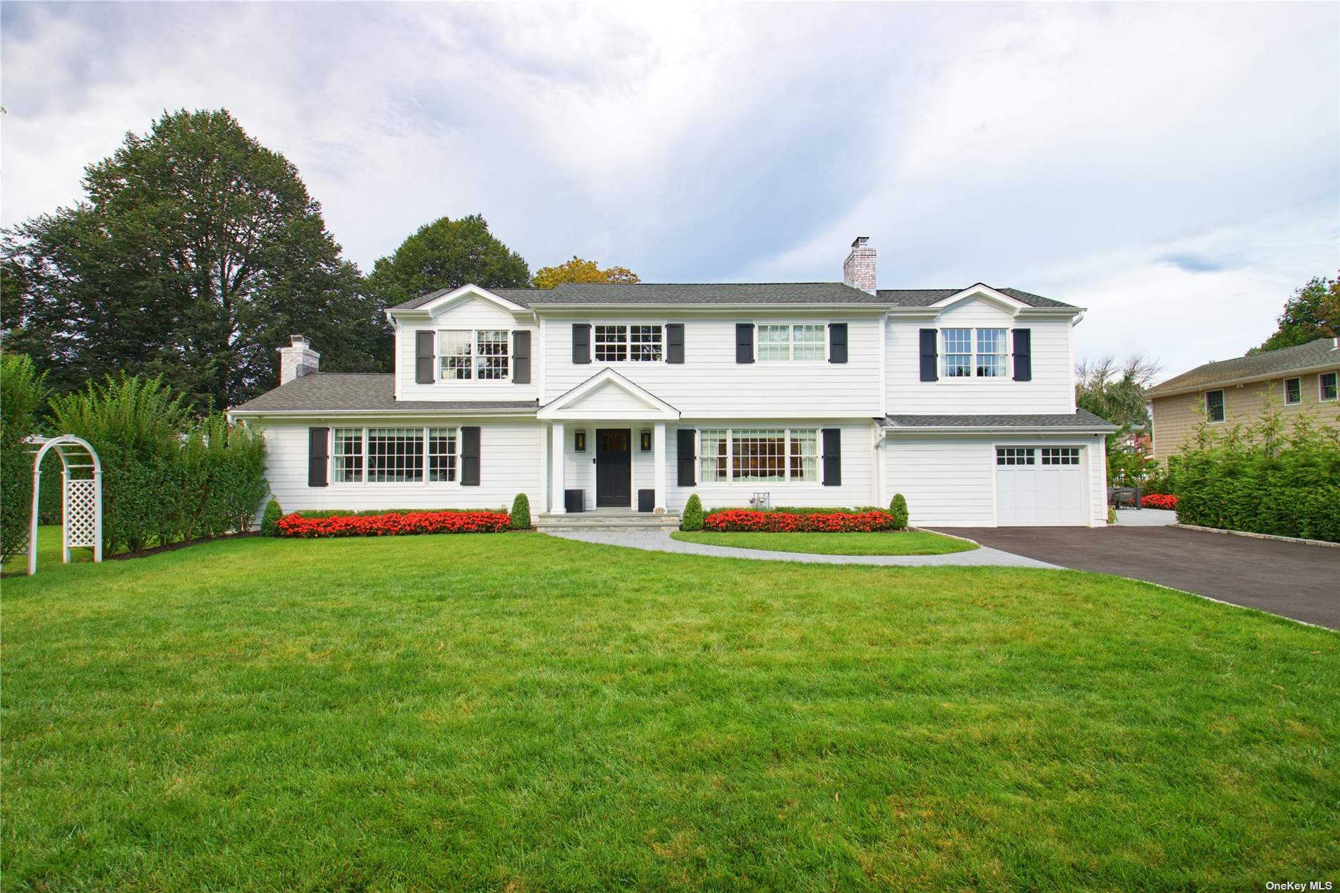 a front view of a house with a garden