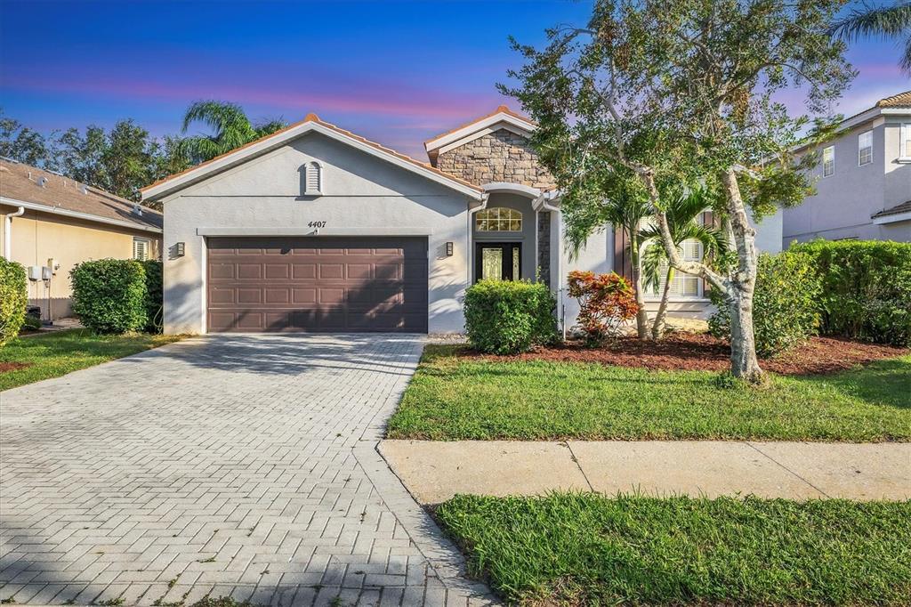 a front view of a house with a yard and garage