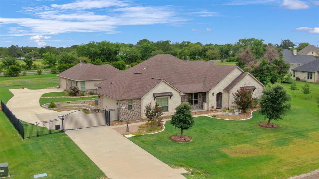 a aerial view of a house with a yard table and chairs