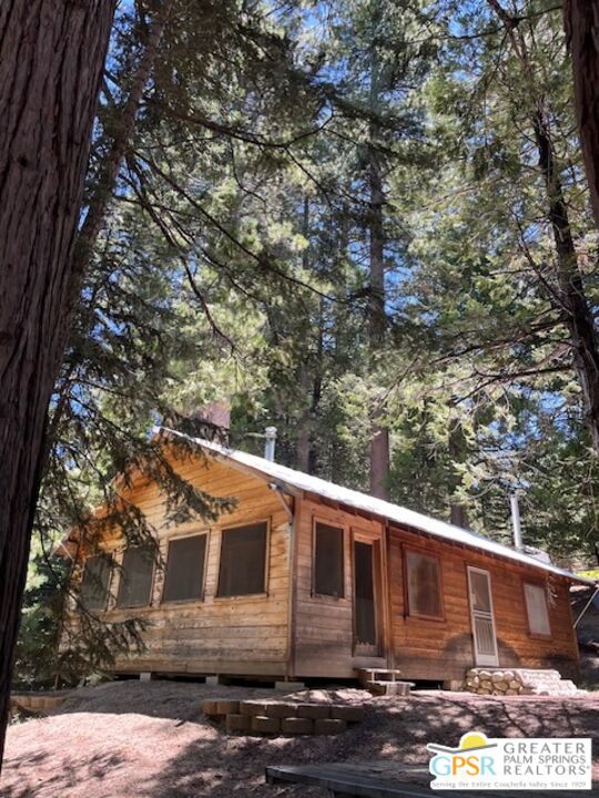 a view of a house with a tree