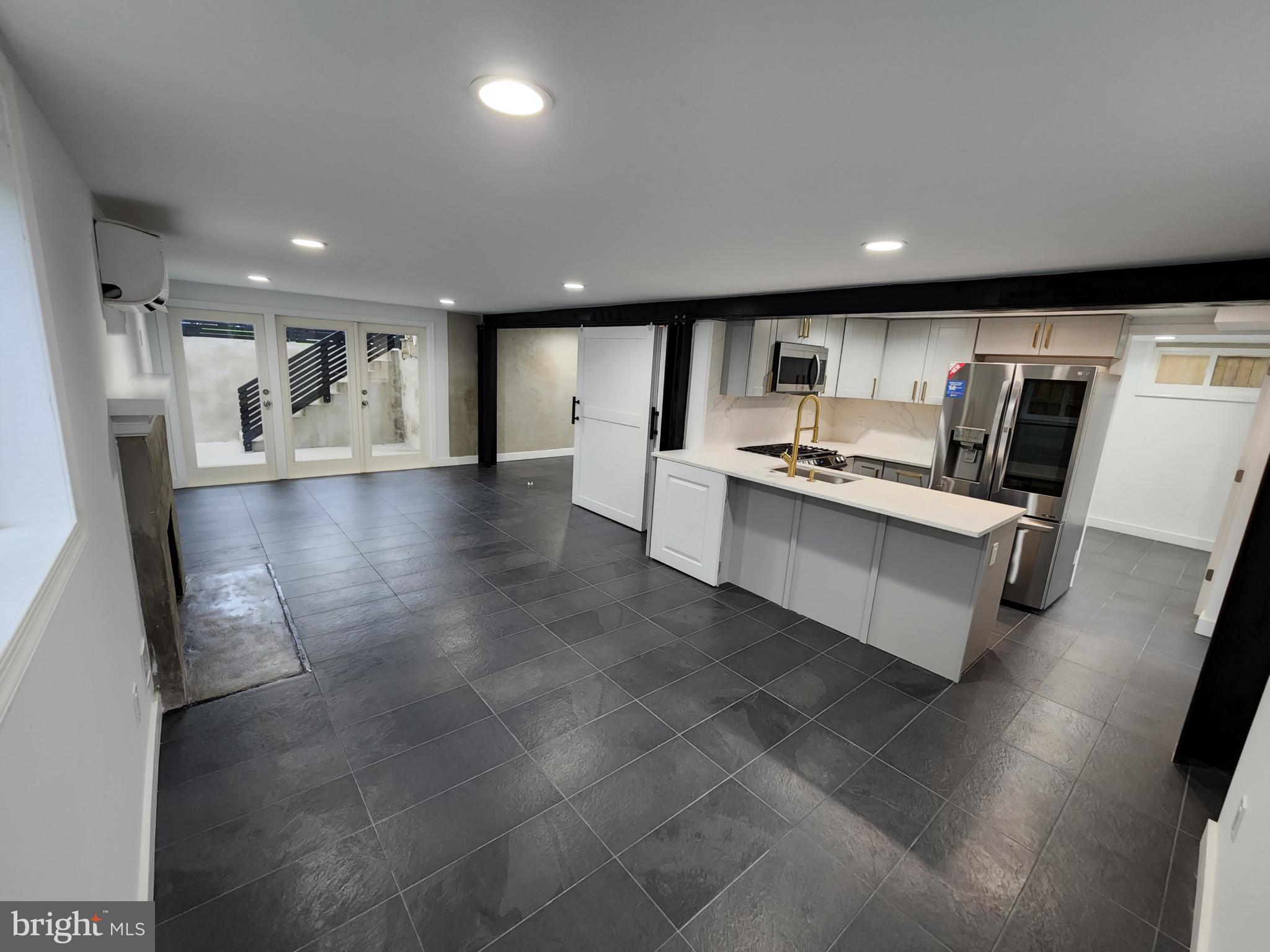 a view of a kitchen with a sink and microwave