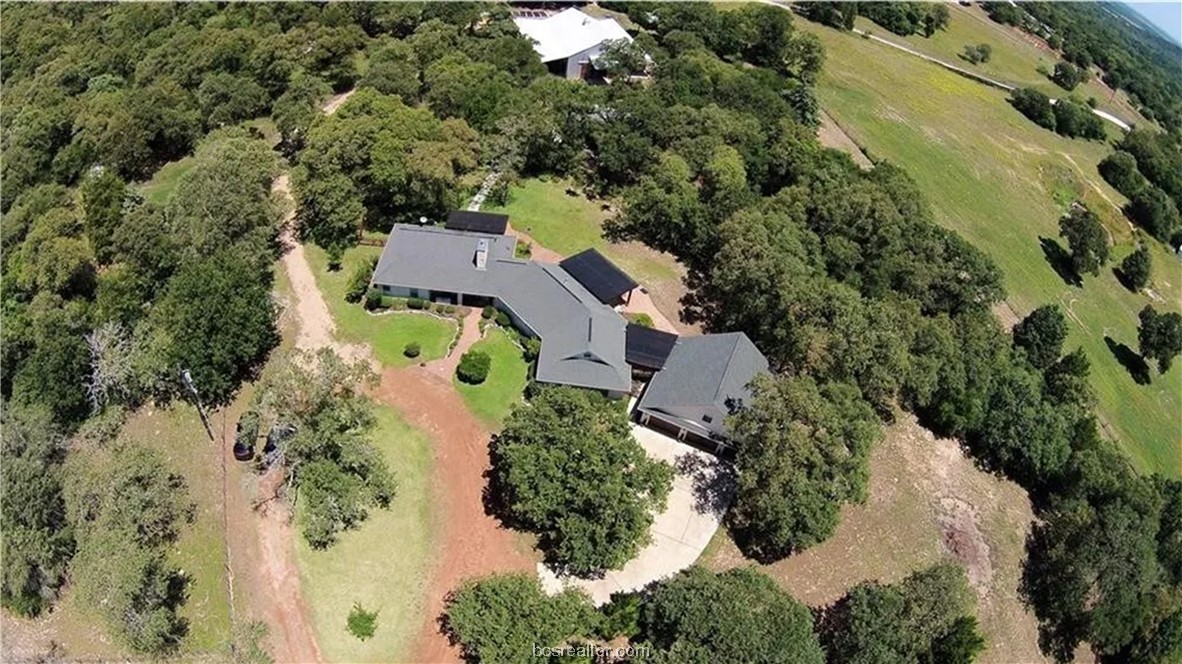 an aerial view of a house with a yard