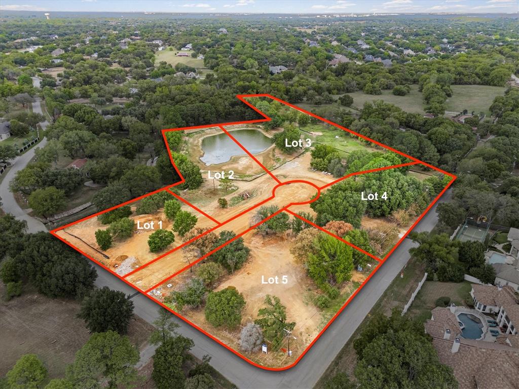 an aerial view of a pool and a yard