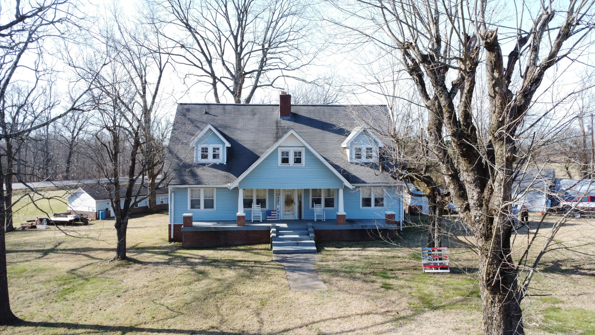 a front view of a house with a yard covered in snow