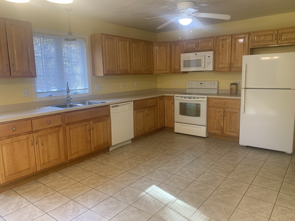 a kitchen with appliances cabinets and a sink