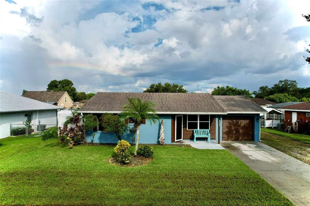 a view of a house with a yard and sitting area