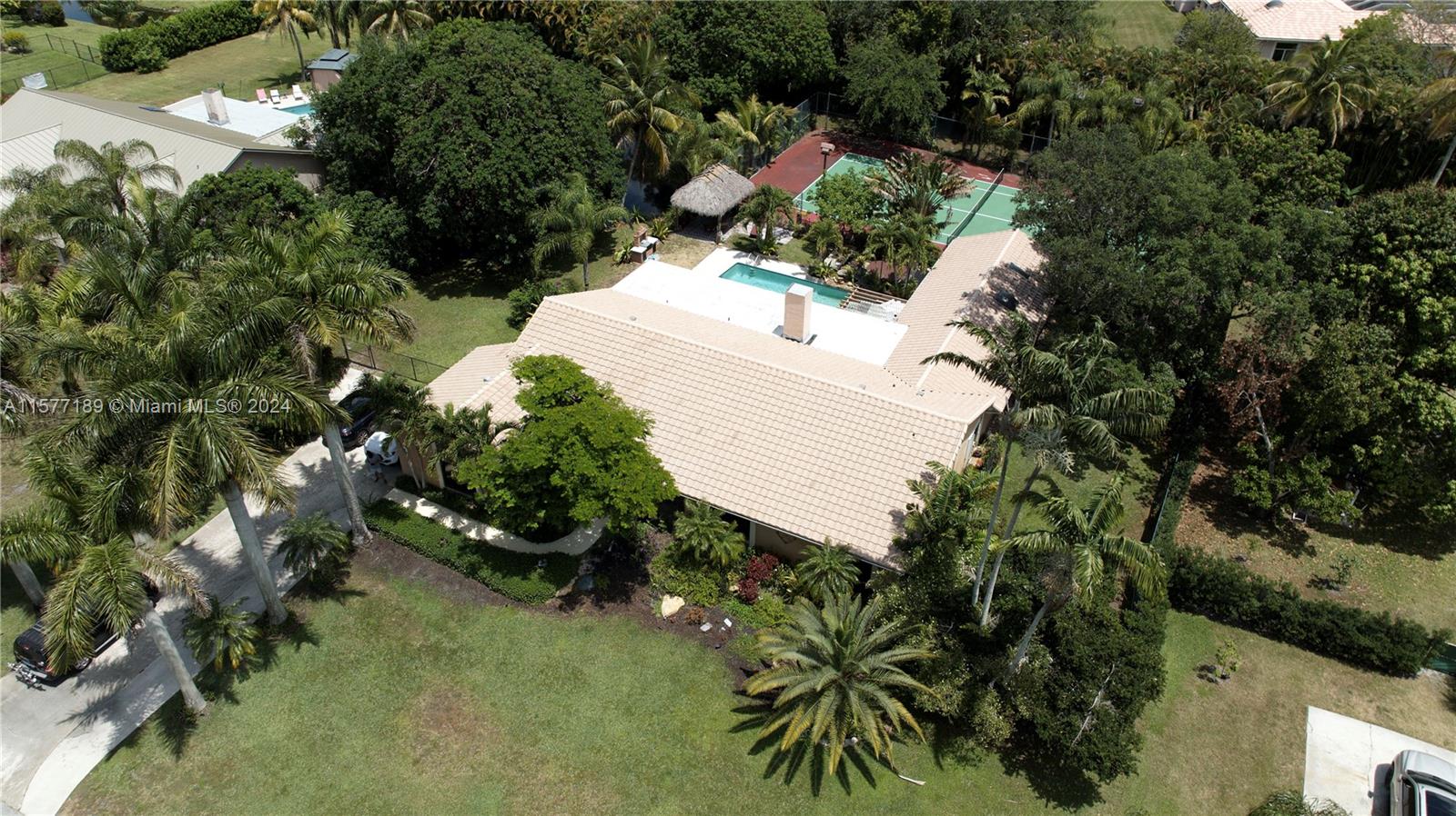 an aerial view of a house with a yard and lake view