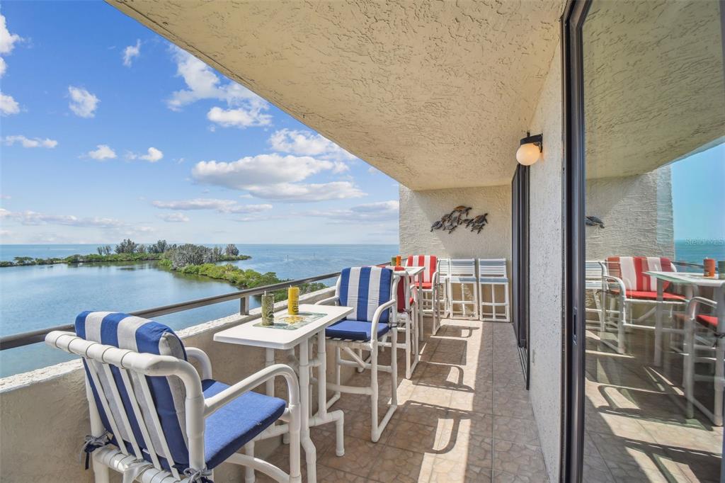 a balcony with table and chairs