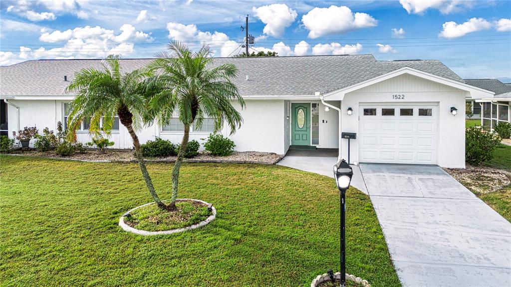 a view of a house with a swimming pool and a yard