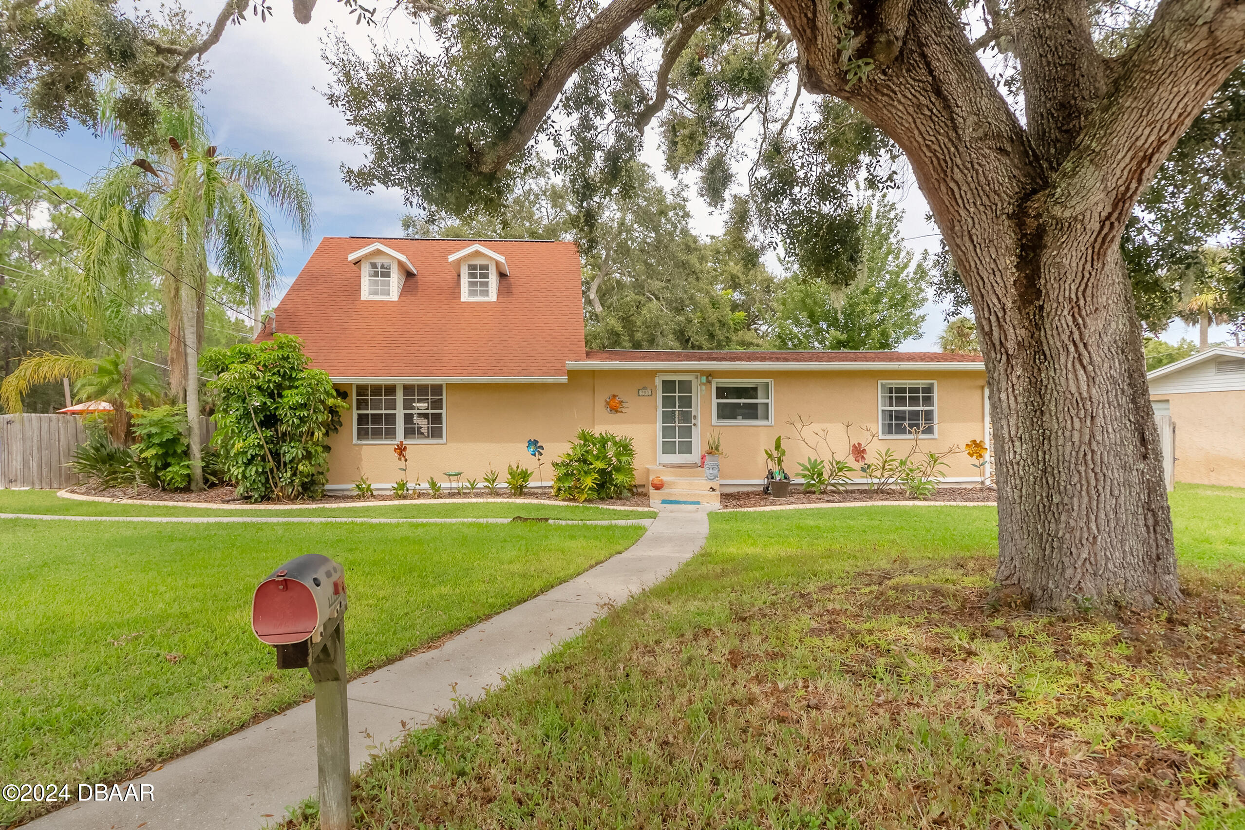 a front view of a house with garden