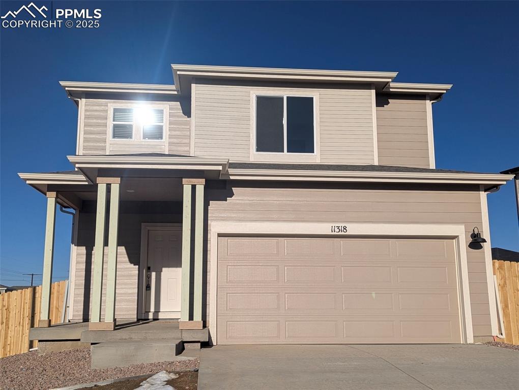 View of front of property featuring a garage