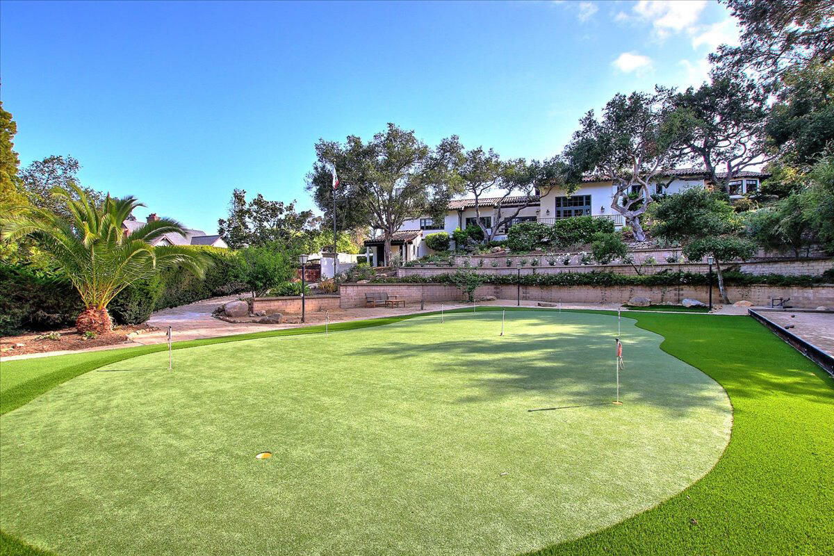 a swimming pool view with a outdoor seating and garden