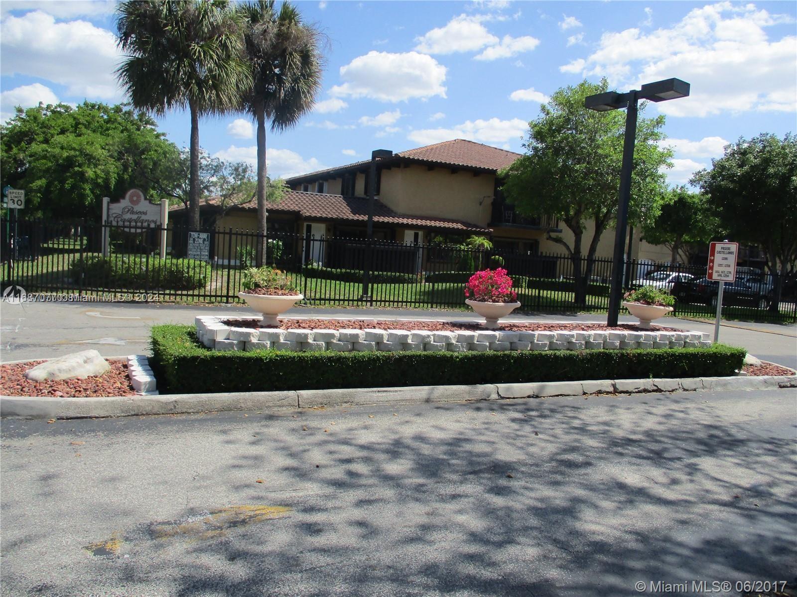 a front view of a house with a yard and lake view